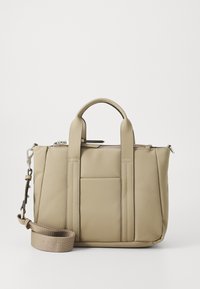 Beige tote bag made of smooth material, featuring two top handles, a detachable strap, and a front pocket. Zip closure at the top.