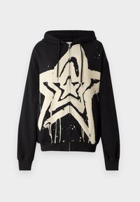 Black zip-up hoodie features a large cream star graphic with dripping paint effect. Textured fabric with long sleeves and a drawstring hood.