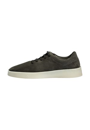 Dark grey suede low-top sneaker with black laces and thick white rubber sole, shown from the side on white background.