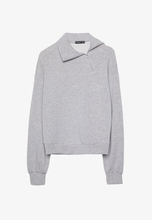 Grauer Reißverschluss-Sweatshirt mit hohem Kragen, langen Ärmeln und lockerer Passform, gefertigt aus weichem, strukturiertem Stoff. Keine Muster oder Akzente sichtbar.