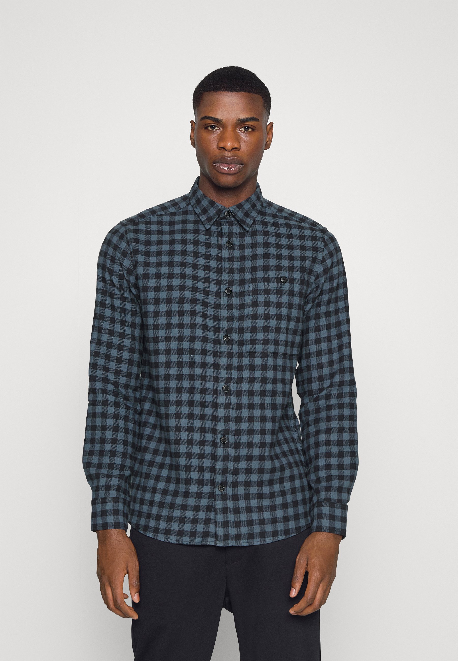 blue checkered shirt grey pants