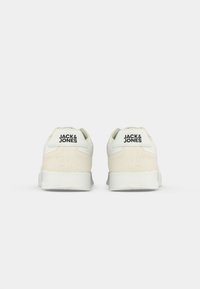 Pair of white Jack & Jones sneakers shown from the back, featuring suede texture and branded heel tabs on a plain white background.