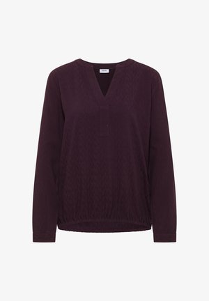 Haut à manches longues en V en tissu texturé violet foncé avec une coupe ample, présentant un ourlet froncé et des détails de motif subtils.