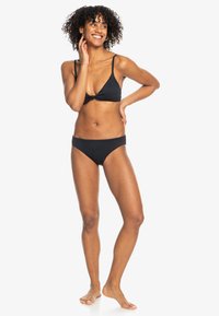 Black bikini with a triangle top featuring adjustable straps and a knot detail. The bottoms are classic cut, made of smooth fabric.