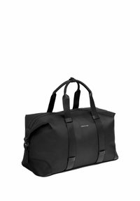 Bolso de lona negro con asas dobles, cierre de cremallera y logo "Cerruti 1881" centrado en un lateral.