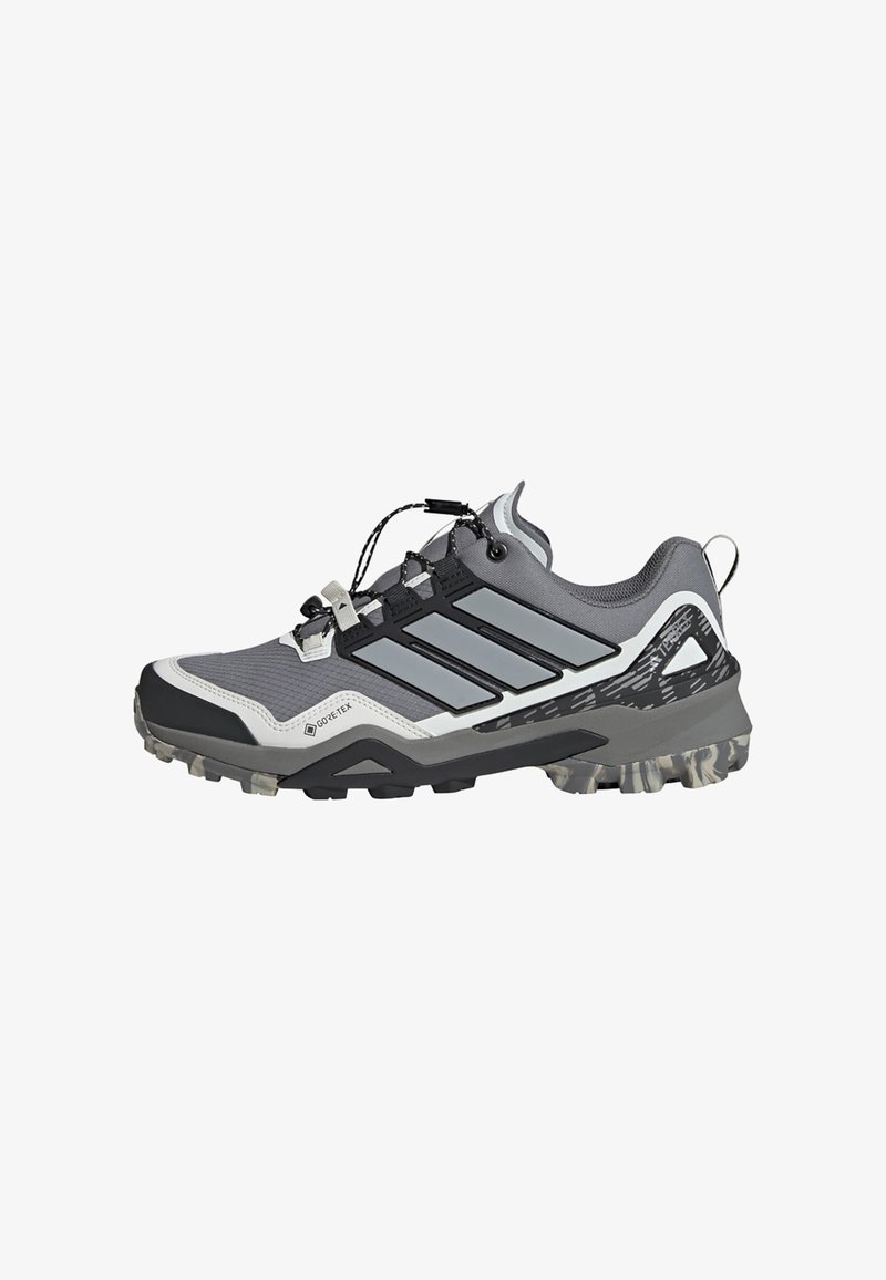 Lightweight gray and black trail shoe with a textured upper, reflective accents, and a rugged sole for traction. Features GORE-TEX material.