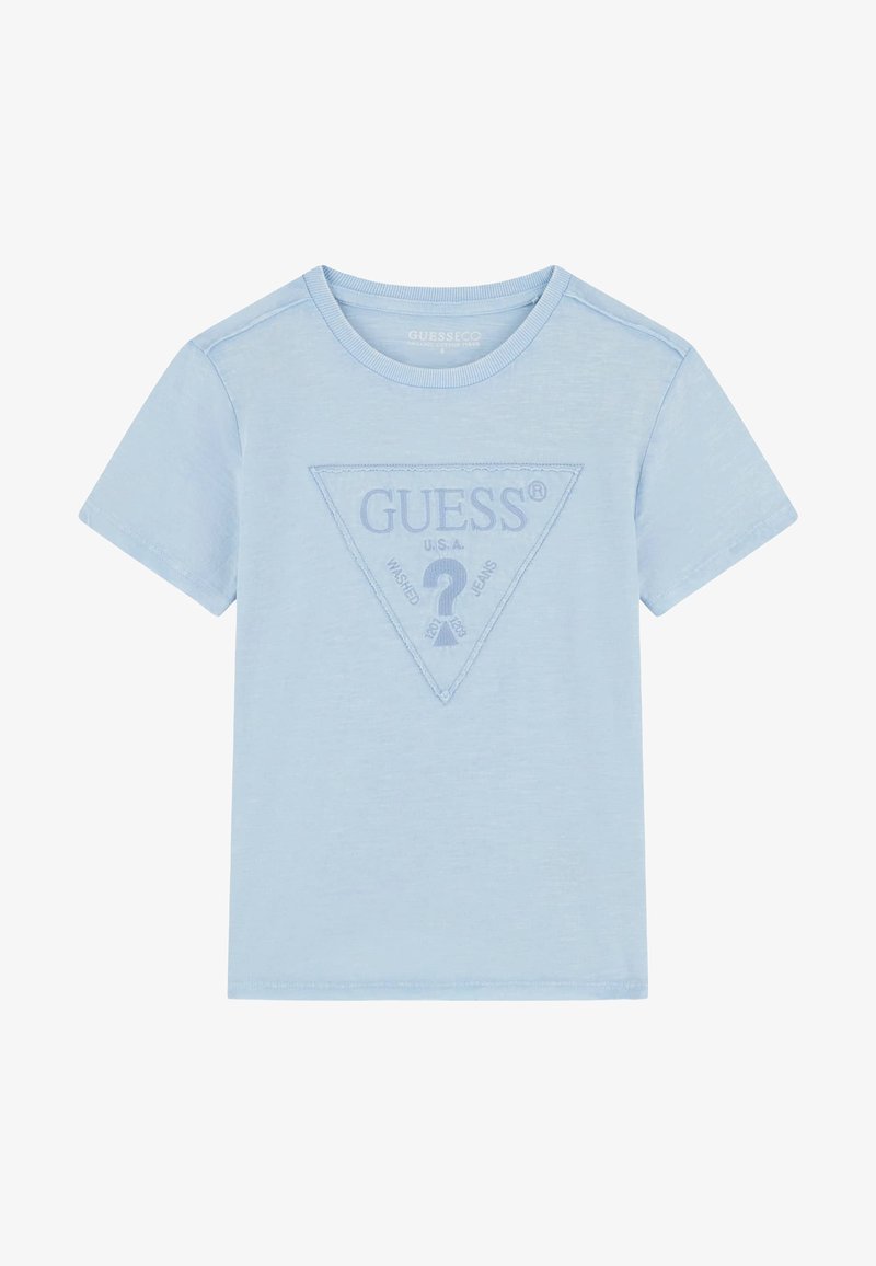 Világoskék, rövid ujjú póló, háromszög alakú domború logóval, melyen a "GUESS" szó és egy kérdőjel található a közepén. Puha tapintású.