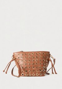 Brown leather bag with metal eyelet accents, rounded shape, double drawstrings, and zip closure. Textured surface with circular patterns.