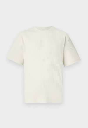 Világos bézs bordázott póló, rövid ujjal és kerek nyakkivágással, sima fehér háttér előtt bemutatva.