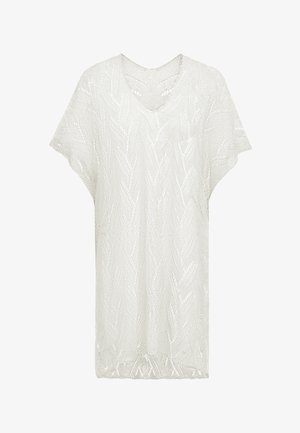 Biała dzianinowa bluzka z dekoltem w serek, krótkimi rękawami i teksturowanym wzorem w zygzak. Lekka i luźna konstrukcja, odpowiednia do noszenia warstwowo.