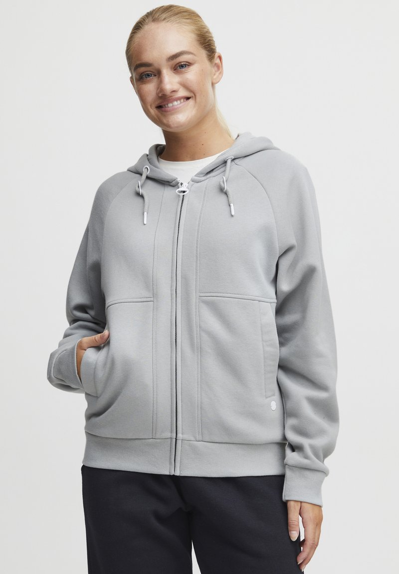 Gray zip-up hoodie made of soft material, featuring a lined hood, front pockets, and ribbed cuffs, with a smooth texture and a relaxed fit.