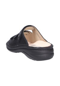 Schwarzer Leder-Schlupfschuh mit runder Zehenpartie, gepolstertem Innenraum und geformter Gummisohle. Verfügt über eine Stichnaht entlang der Kanten und Aussparungen an den Seiten.