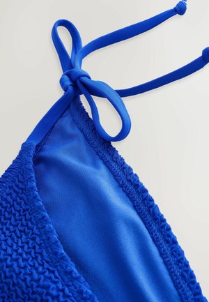 Blue bikini top featuring a smooth inner fabric and textured outer trim. Ties with a knot on each side for adjustable fit.