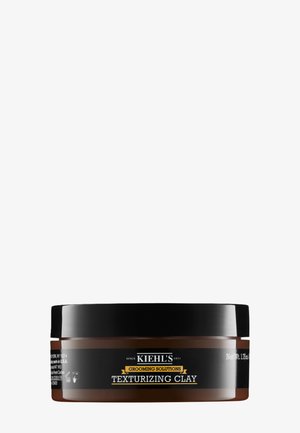 Kiehl's Grooming Solutions - tekstureringsleret i en rund, mørkebrun krukke med sort låg; har hvide og gule tekstetiketter. 118 ml.