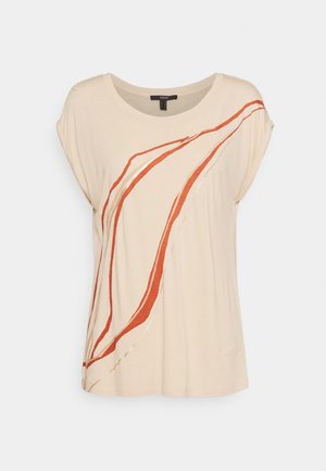 Beige T-shirt with loose sleeves, featuring abstract red and white lines. Made of soft material with a round neckline and relaxed fit.