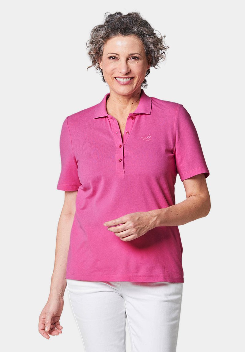 Rosa Poloshirt aus weichem Stoff, mit einem Knopfverschluss und kurzen Ärmeln. Logo auf der linken Brust gestickt.