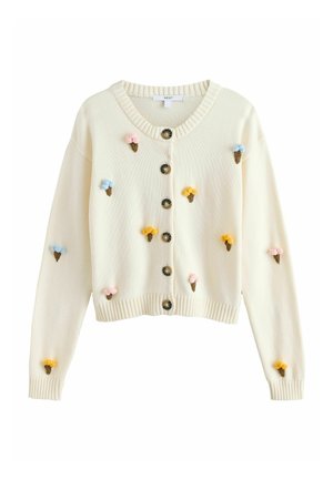 Krémový pletený sveter s gombíkmi vpredu, zdobený malými ružovými, modrými a žltými aplikáciami zmrzlinových kornútov vpredu a na rukávoch.