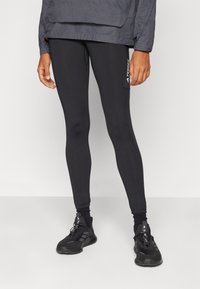Sorte leggings har en tætsiddende pasform, høj talje og en sidelomme med "TERREX" branding. Fremstillet af strækbart, glat materiale.