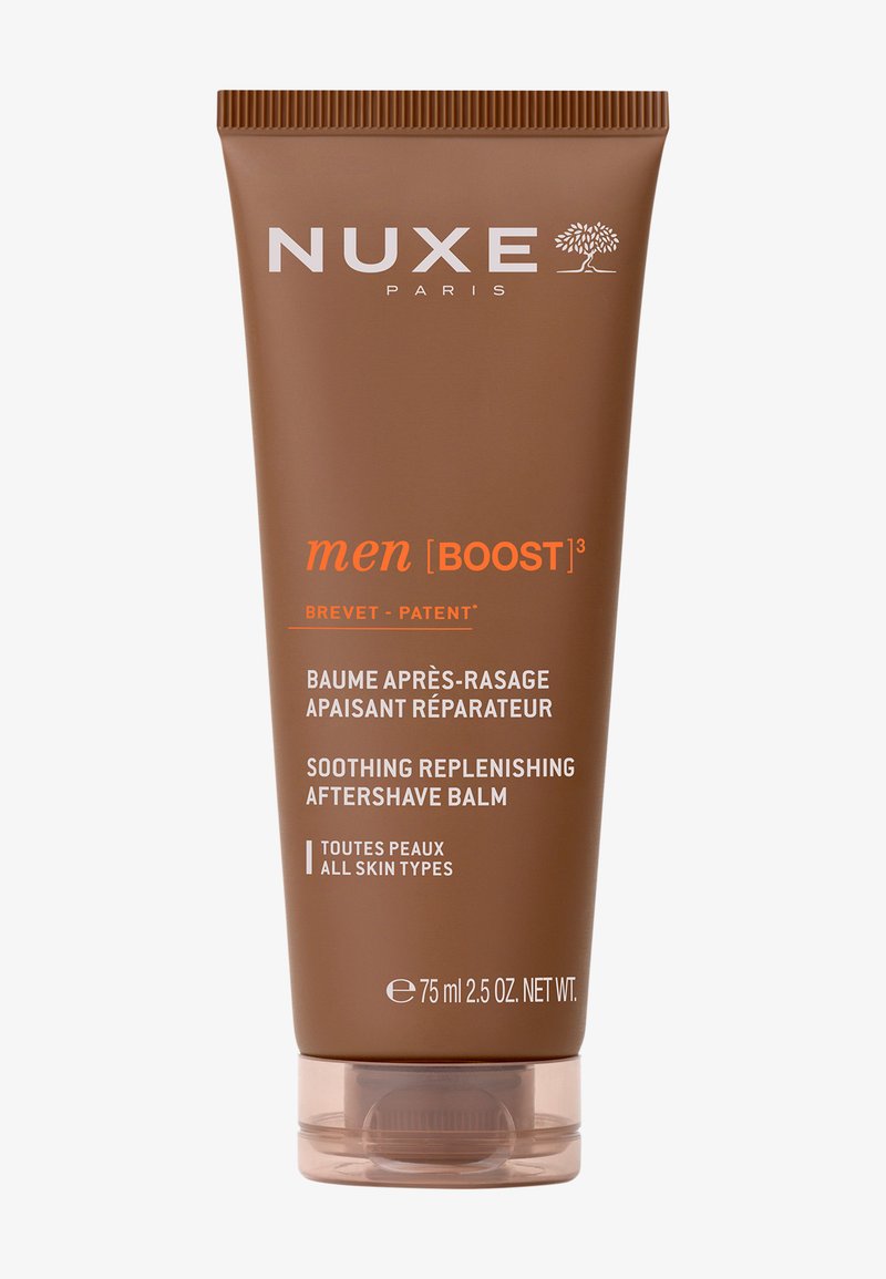 Envase tubular marrón con acabado mate, que presenta texto en blanco y naranja. Contiene 75 ml de bálsamo aftershave suavizante para todo tipo de piel.