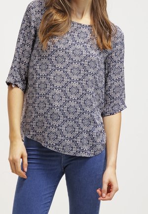 Navybluse mit floralem Muster, kurzen Ärmeln und leicht gewelltem Saum. Aus leichtem Stoff mit glatter Textur gefertigt.