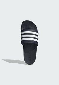 Navy slide sandal with three white horizontal stripes on the upper band. Made of smooth synthetic material, featuring a textured footbed.