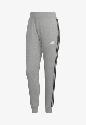 Pantalons de sport gris en mélange de coton, avec une coupe ajustée, des bandes latérales noires et des poignets élastiques. Logo Adidas sur la hanche gauche.