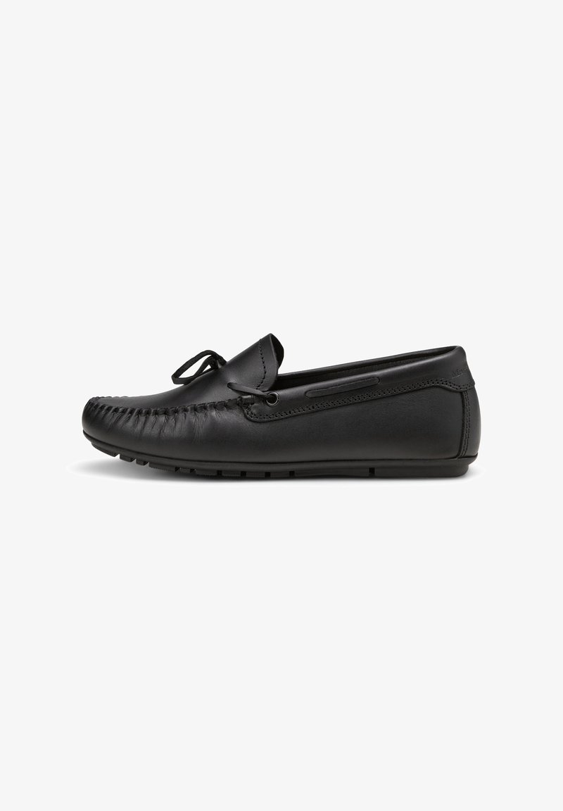 Black leather moccasin shoe with a rounded toe, decorative stitching, lace detail, and a flexible rubber sole. Smooth texture, minimalist design.