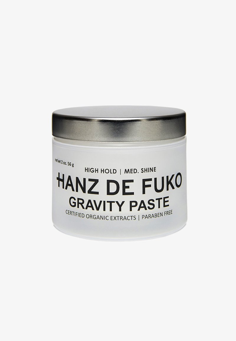Frosted glass jar with a silver metal lid. Black text on the front states “Hanz de Fuko Gravity Paste,” indicating high hold and medium shine.