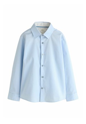 Gaiši zila gara piedurkne kreklā ar pogājamu priekšu, klasisku apkakli un rakstainu iekšējo oderi apkaklē. Gluda auduma tekstūra.