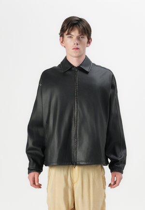 Black leather jacket with a collar, zip closure, elastic cuffs, and a relaxed fit. Smooth texture with a subtle sheen.