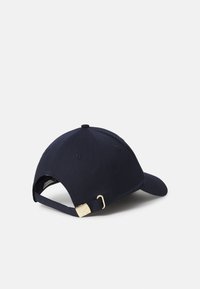 Navy baseball cap made of cotton, featuring a curved brim, adjustable strap, and gold buckle hardware at the back.