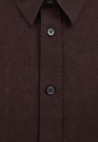 Dark brown button-up shirt with pointed collar and dark grey buttons down the front placket.