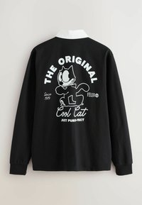 Camisa negra de manga larga con un cuello blanco y un gráfico de Félix el Gato. El texto incluye "EL ORIGINAL" y "Gato Genial" en letras blancas.