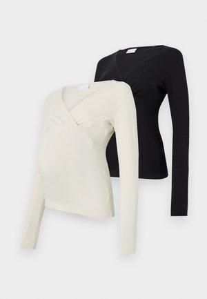 Two long-sleeved maternity tops: one in light cream, the other in black. Both feature a wrap design and soft fabric texture.