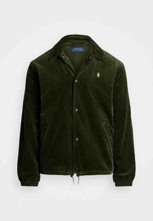 Dunkelgrüne Cordjacke mit Druckknöpfen, Kragen, Seitentaschen, elastischen Bündchen und gelbem Polo Ralph Lauren Logo auf der Brust.