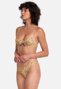 Floral bikini set with a yellow base, featuring multicolored flower patterns. The top has underwire support and adjustable straps.
