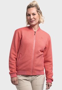 Rosa strukturierte Bomberjacke mit einem Reißverschluss vorne, Rundhalskragen und Rippbündchen. Verfügt über seitliche Taschen und ein kleines Logo auf der Brust.