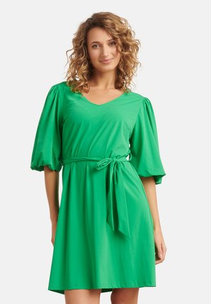 Groene jurk met korte mouwen en een V-hals, vastgezet met een riem op de taille, gemaakt van een glad materiaal met een losse pasvorm en gathered pofdetails op de mouwen.