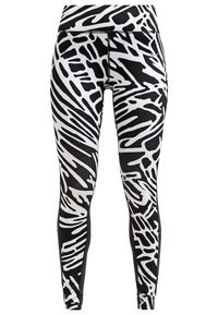 Leggings in bianco e nero con un motivo astratto simile a quello delle zebre, realizzati in tessuto elasticizzato, con una vita alta e un design elegante.