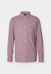 Camicia a maniche lunghe a quadri rossi e bianchi, colletto con bottoni, bottoni bianchi, con un piccolo logo ricamato sul lato sinistro del petto.