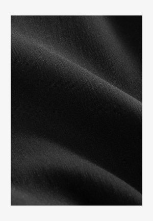 Black fabric with a smooth, matte texture, showing subtle variations in shade and fiber, draped to reveal soft curves and depth.
