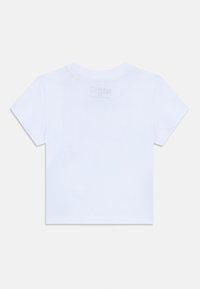 T-shirt en coton blanc à manches courtes, col rond, avec une étiquette imprimée au dos. Texture lisse sans motifs ni accents visibles.