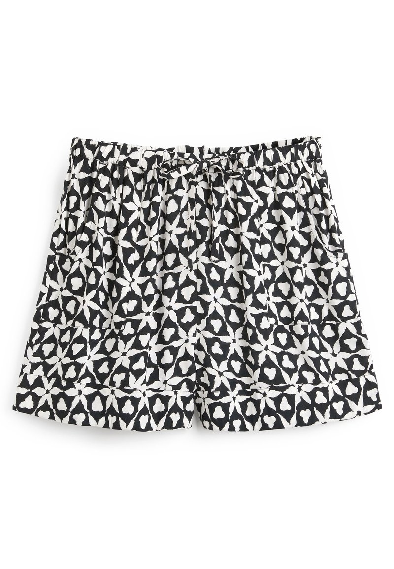 Shorts à motifs en noir et blanc avec taille élastique et cordon de serrage, présentant des formes géométriques abstraites et des poches latérales.