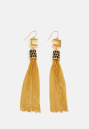 Gold earrings featuring a geometric shape at the top, a textured black and gold honeycomb detail, and long, fine gold chain tassels.