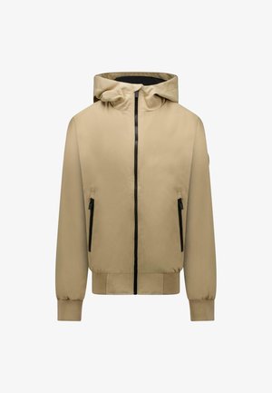 Beige gewatteerde jas met een zwarte ritssluiting aan de voorkant, twee zakken met rits, geribbelde manchetten en een aansluitende tailleband.