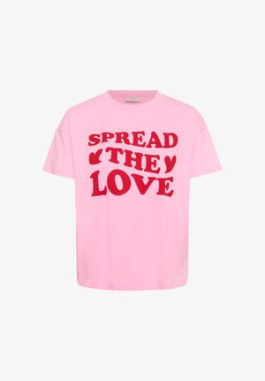 Roza bombažna majica z napisom "ŠIRI LJUBEZEN" z debelimi rdečimi črkami. Kratki rokavi in sproščen kroj.