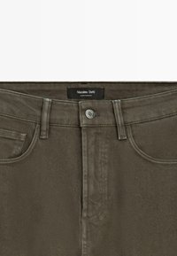 Olive green denim jeans with front button closure, belt loops, and front pockets, labeled Massimo Dutti, made in Morocco.