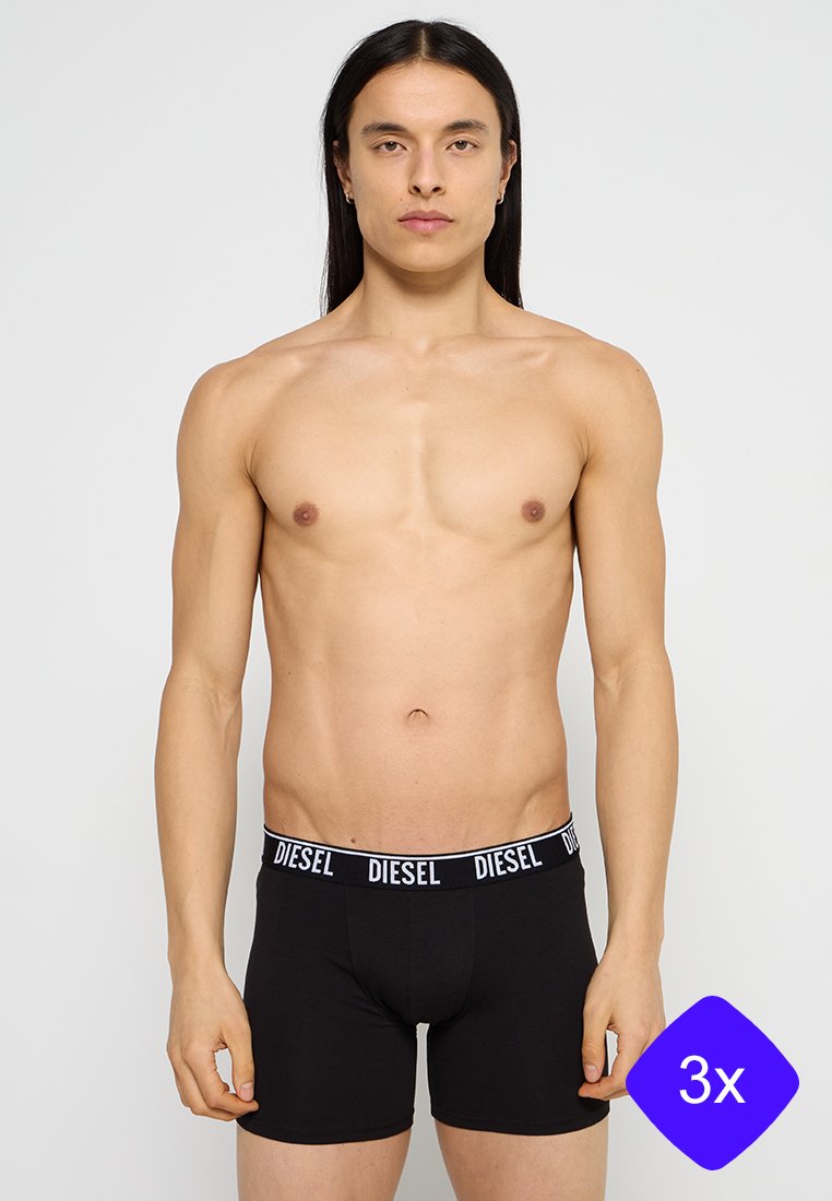 Black boxer briefs made of cotton, featuring a white "DIESEL" logo band. The design includes a snug fit and smooth texture. Pack of three.