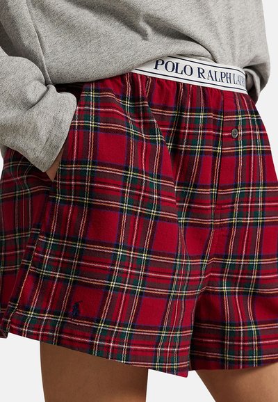 Pehmeästä kankaasta valmistetut punaruudulliset shortsit, joissa on valkoinen vyötärönauha "POLO RALPH LAUREN" -logolla ja sivutaskut.