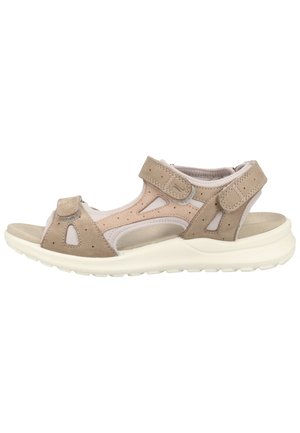 Tan and beige sandal with a suede and mesh upper, adjustable Velcro straps, open-toe design, and a cushioned white sole.